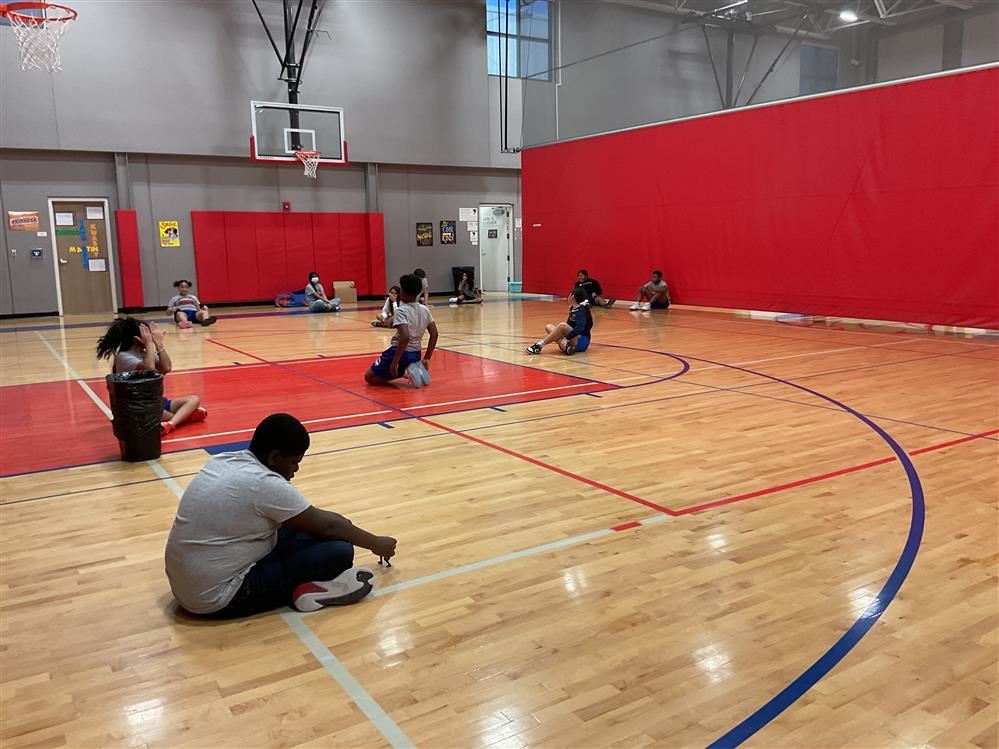 Class picture of students stretching in P.E. Class picture of students stretching in P.E.